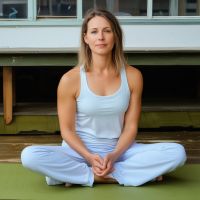 Sarah Williams, gentle yoga instructor in a peaceful meditation pose
